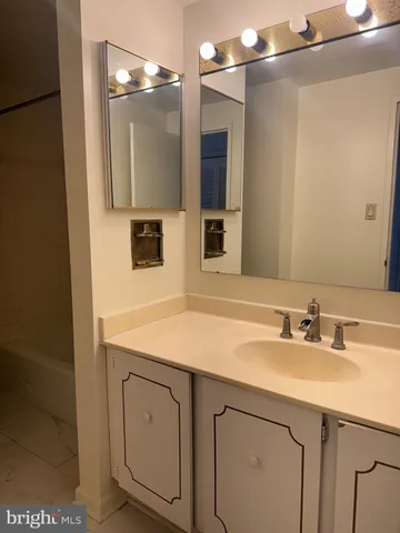 a bathroom with a sink vanity and a mirror