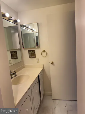 a bathroom with a sink a mirror and vanity