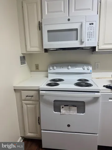 a stove top oven sitting inside of a kitchen