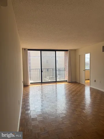a view of an empty room with glass door