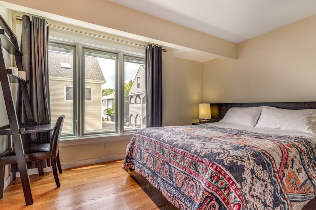 35 Perry Street, Unit 35 Somerville, MA 02143 - Photo 4 of 9 a bedroom with a bed and a window