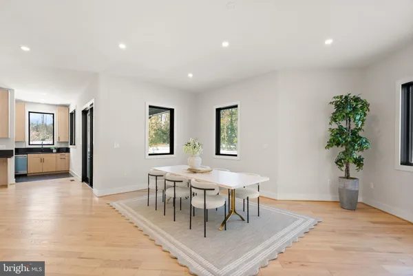 a bathroom with a granite countertop sink a toilet and mirror