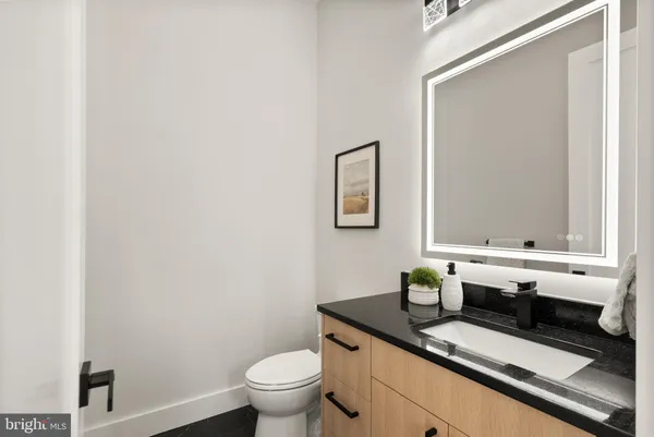 a kitchen with granite countertop a stove and a refrigerator