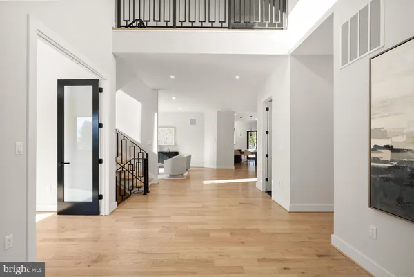 a living room with furniture and a dining table with wooden floor