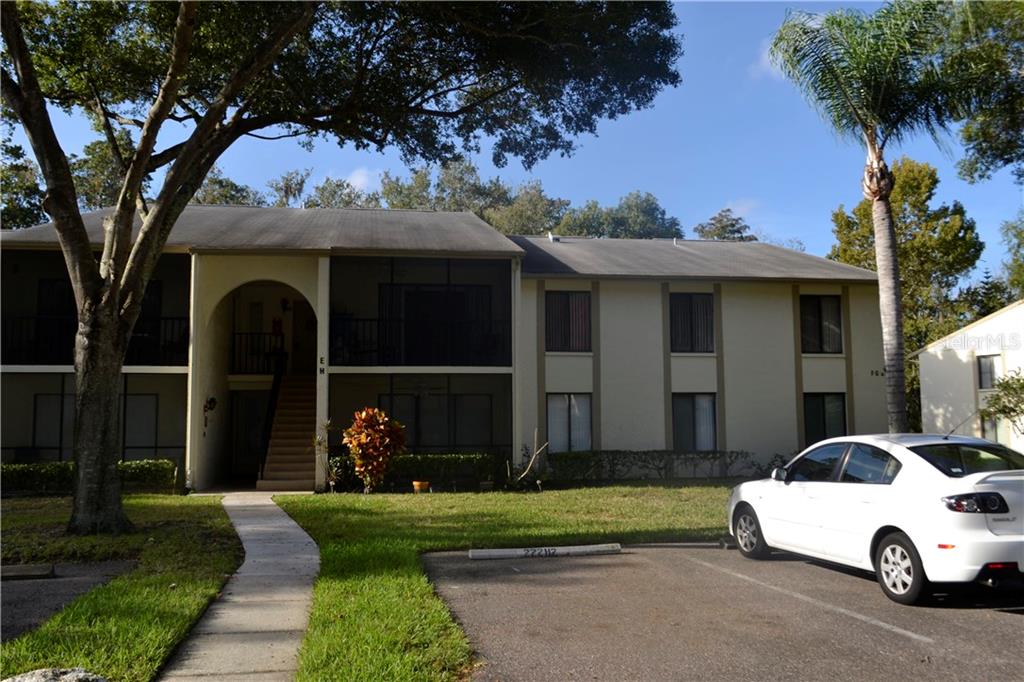 a car parked in front of white house