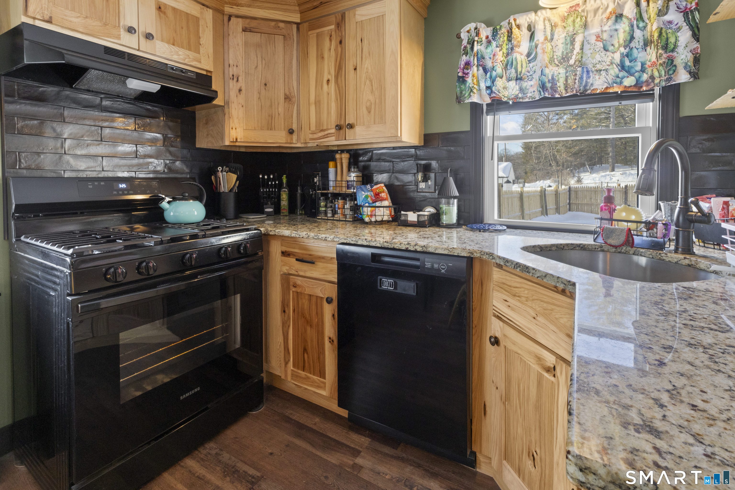 17 Auburn Street Putnam, CT 06260 - Photo 4 of 9 a kitchen with stainless steel appliances granite countertop a stove a sink and a microwave