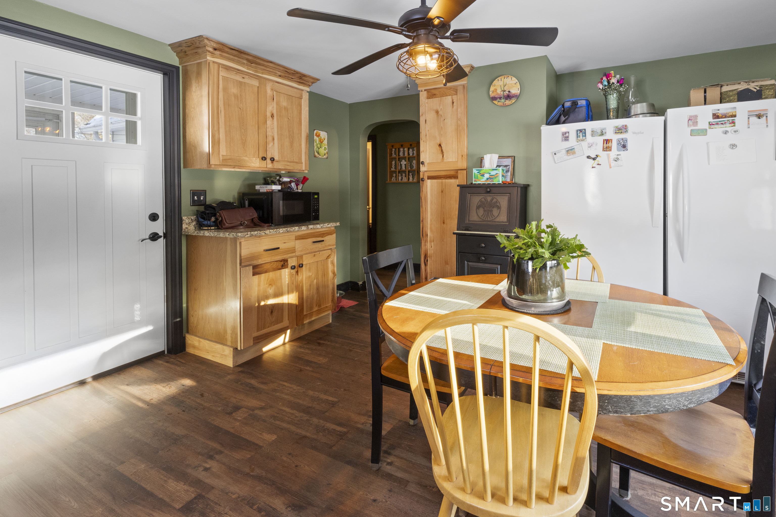 17 Auburn Street Putnam, CT 06260 - Photo 5 of 9 a dining room with wooden floor a chandelier a wooden table and chairs