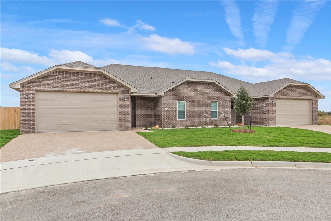 705 Tower Mill Robinson, TX 76706 - Photo 2 of 15 a front view of a house with a garden and garage