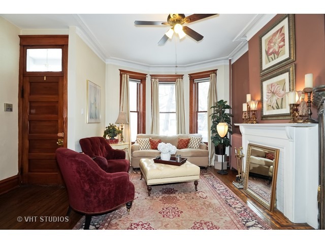 2157 North Seminary Avenue, Unit A Chicago, IL 60614 - Photo 2 of 15 a living room with furniture a fireplace and a chandelier