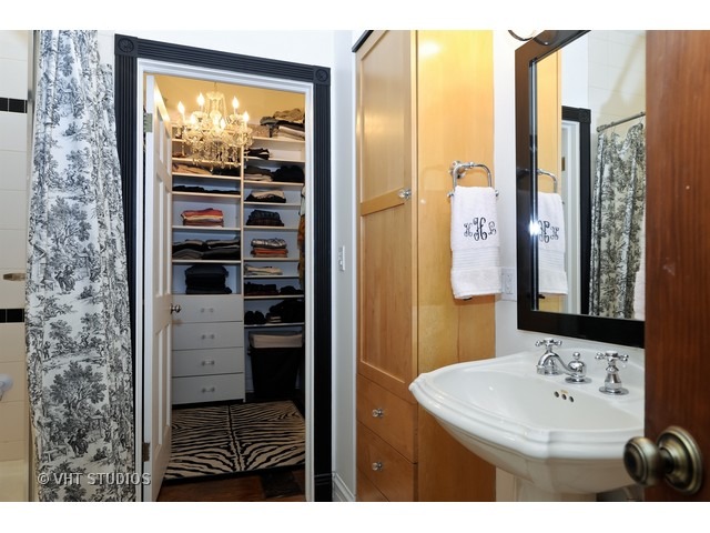 2157 North Seminary Avenue, Unit A Chicago, IL 60614 - Photo 14 of 15 a bathroom with a sink a mirror and a shower