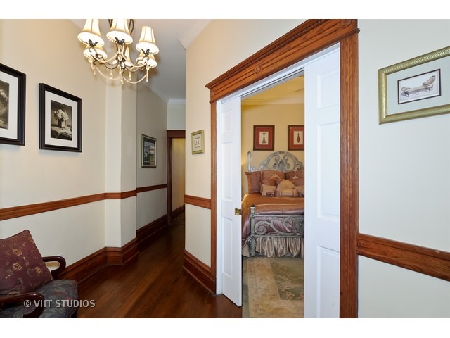 2157 North Seminary Avenue, Unit A Chicago, IL 60614 - Photo 4 of 15 a view of a hallway with wooden floor and chandelier