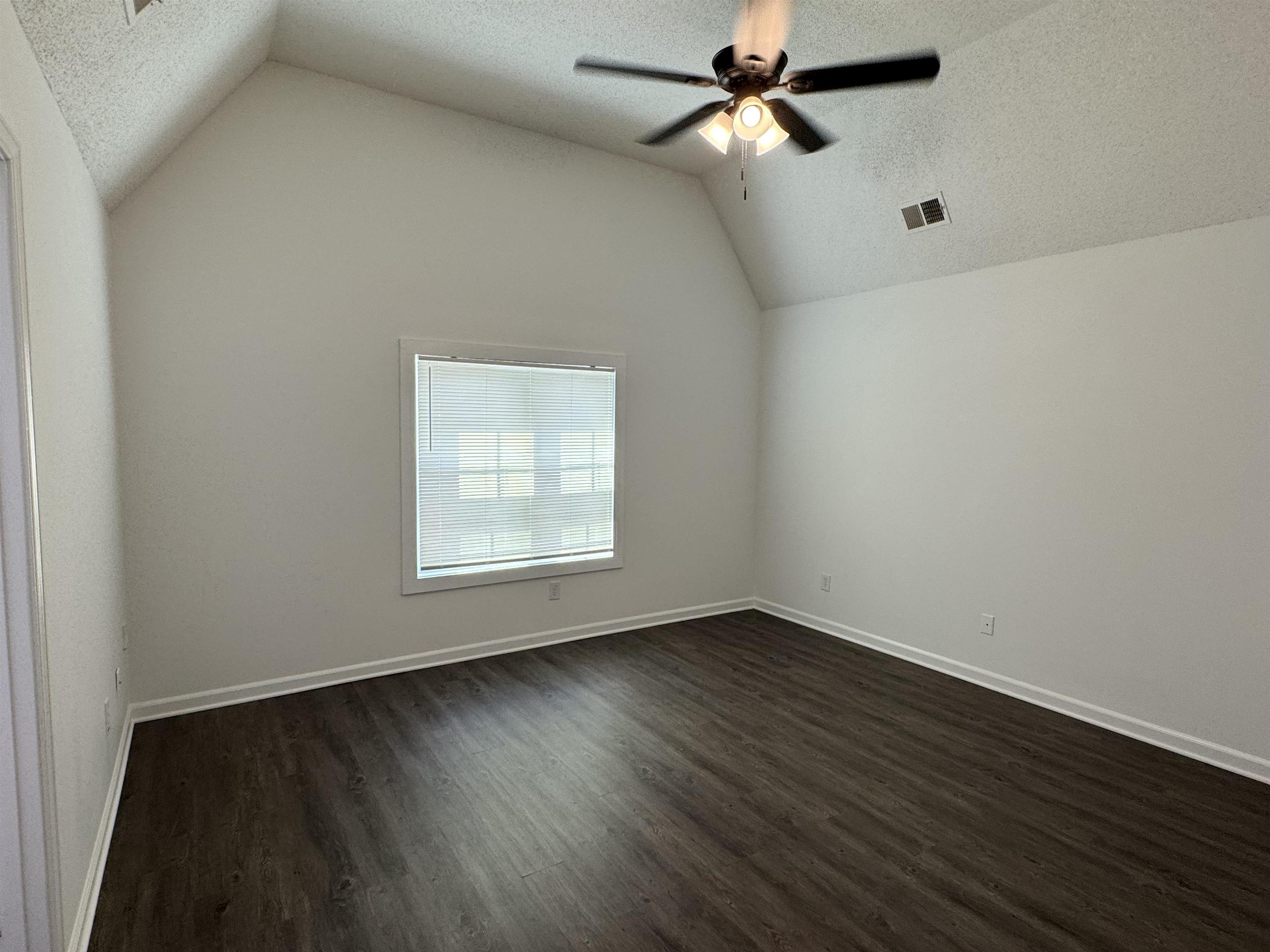 6932 Snyder Road Memphis, TN 38141 - Photo 12 of 15 wooden floor in an empty room with a window