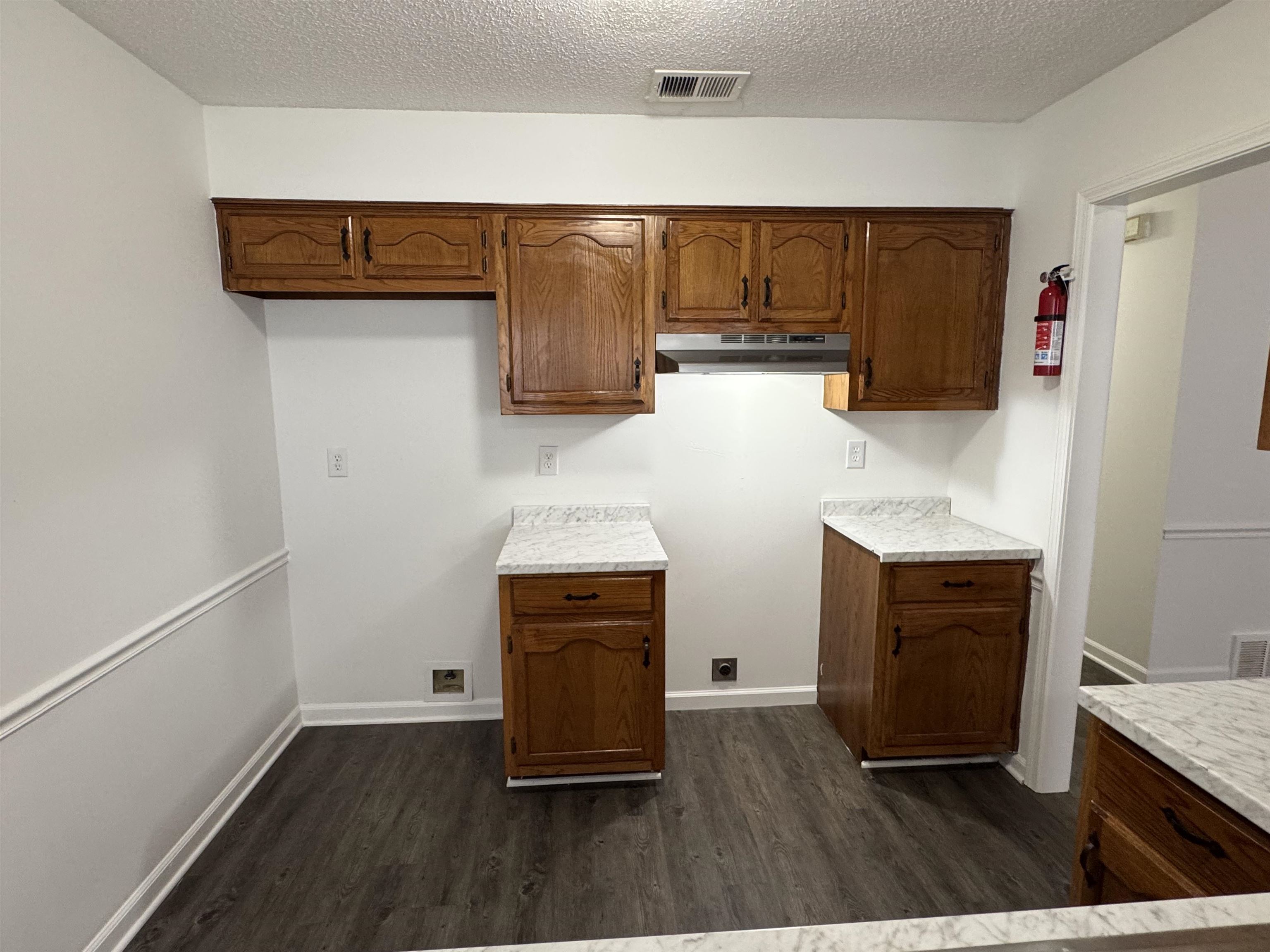 6932 Snyder Road Memphis, TN 38141 - Photo 6 of 15 a kitchen with wooden cabinets and a stove top oven