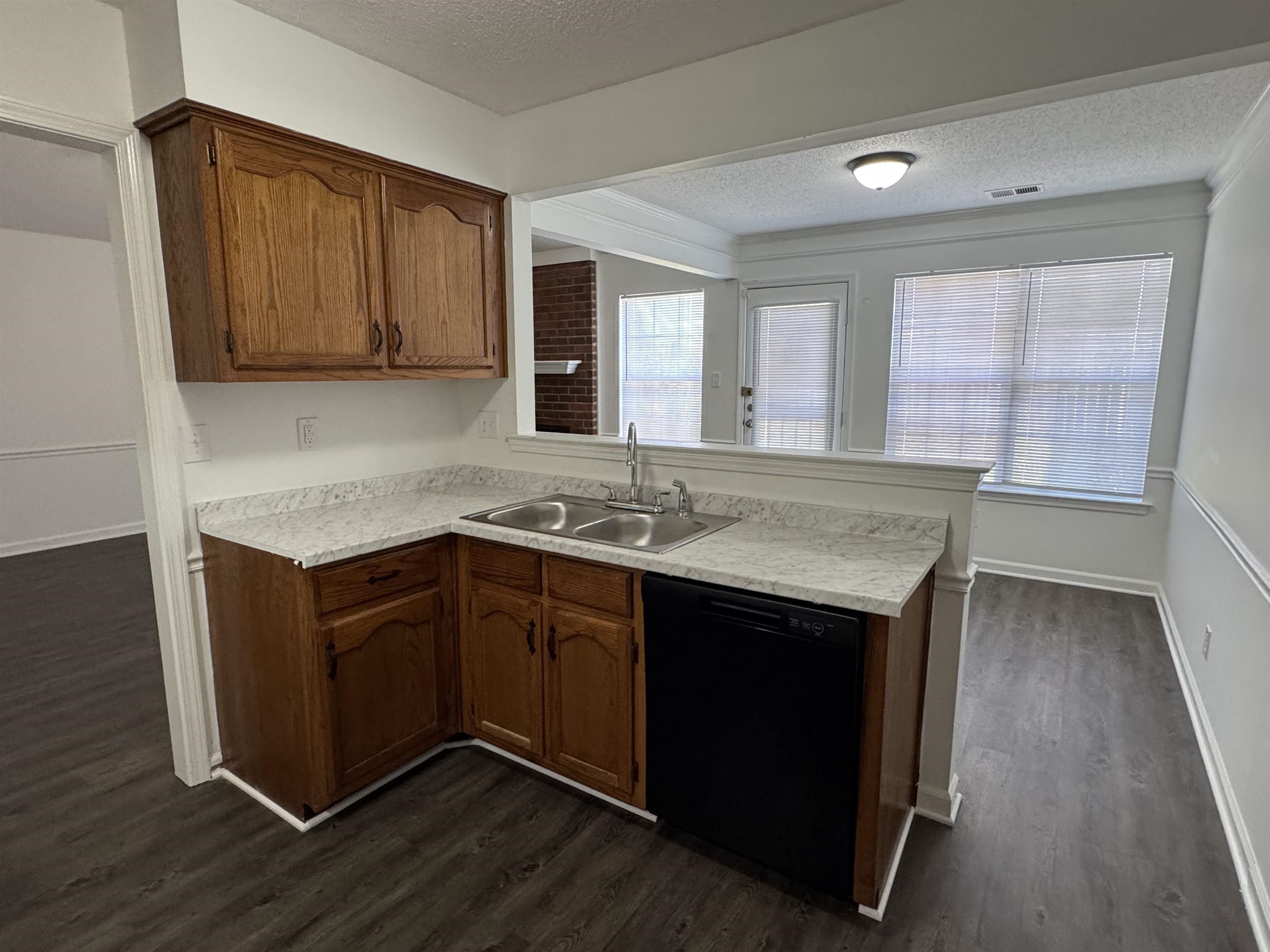 6932 Snyder Road Memphis, TN 38141 - Photo 7 of 15 a kitchen with granite countertop a sink cabinets and wooden floor