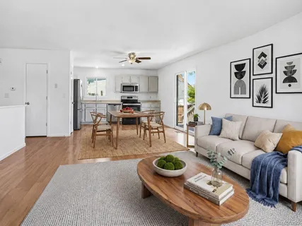 a living room with furniture and wooden floor