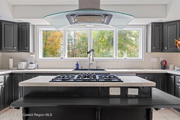 a bathroom with a granite countertop sink a mirror and a window
