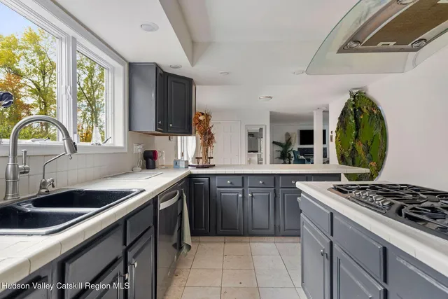 a bathroom with a granite countertop sink a mirror and a window