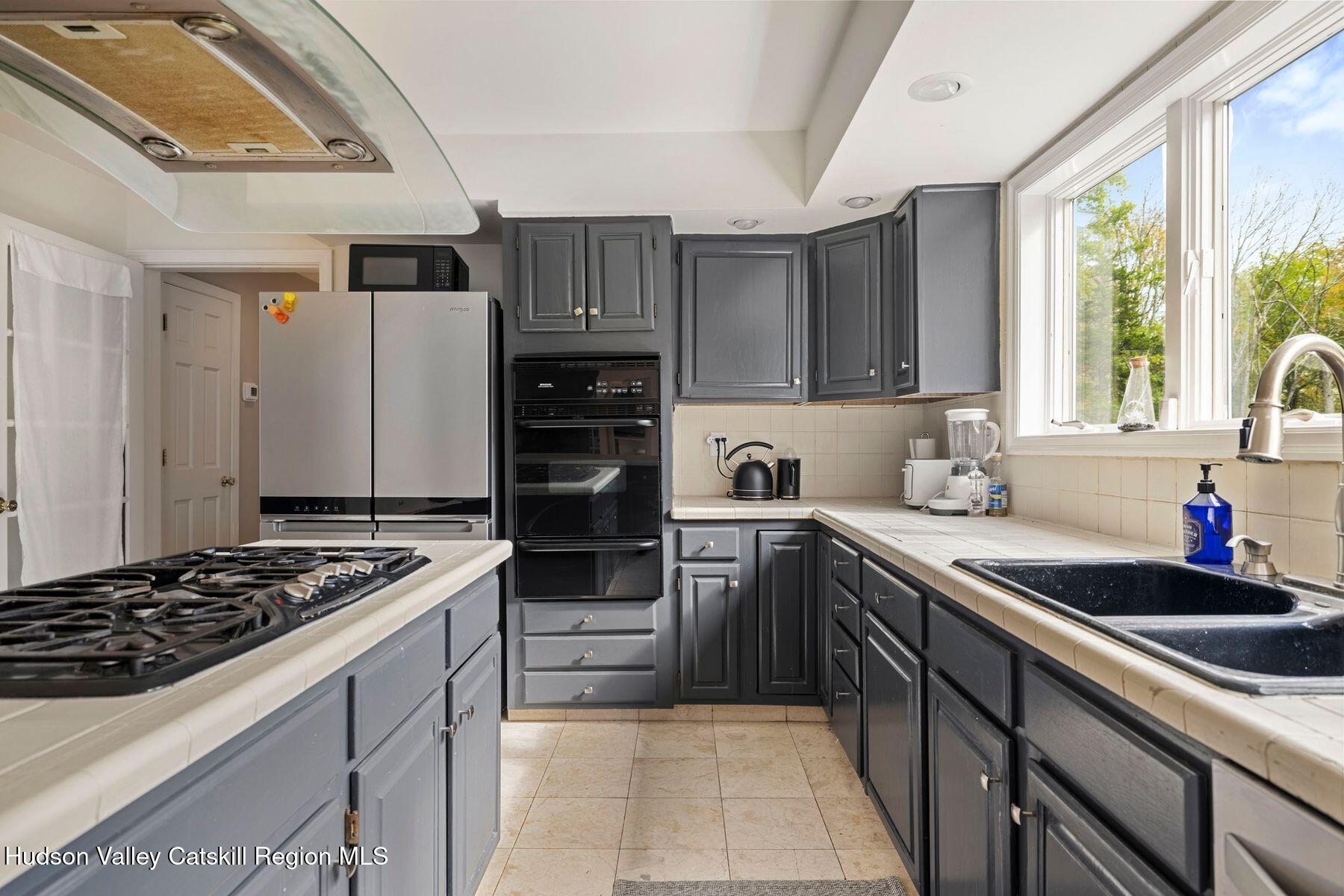 2935 Rte 44 55 Gardiner, NY 12525 - Photo 24 of 87 a kitchen with kitchen island granite countertop a sink stove and refrigerator