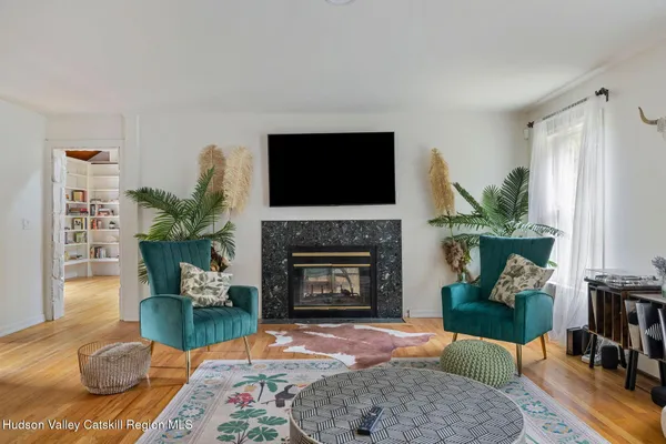 a living room with furniture a flat screen tv and a fireplace