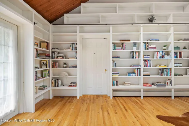 a view of a deck with couches table and chairs with wooden floor and fence