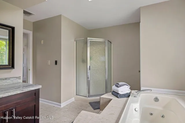 a front view of a house with yard and green space