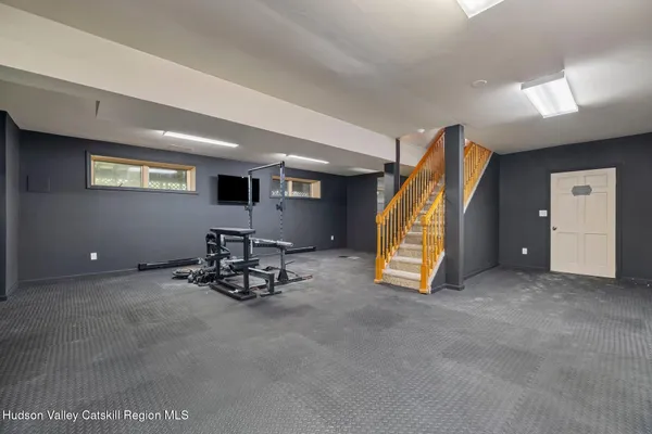 an aerial view of a house with a yard basket ball court and outdoor seating