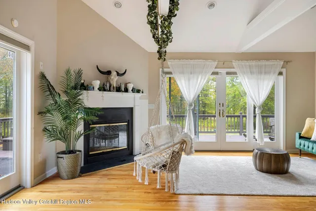 a living room with a couch and a potted plant
