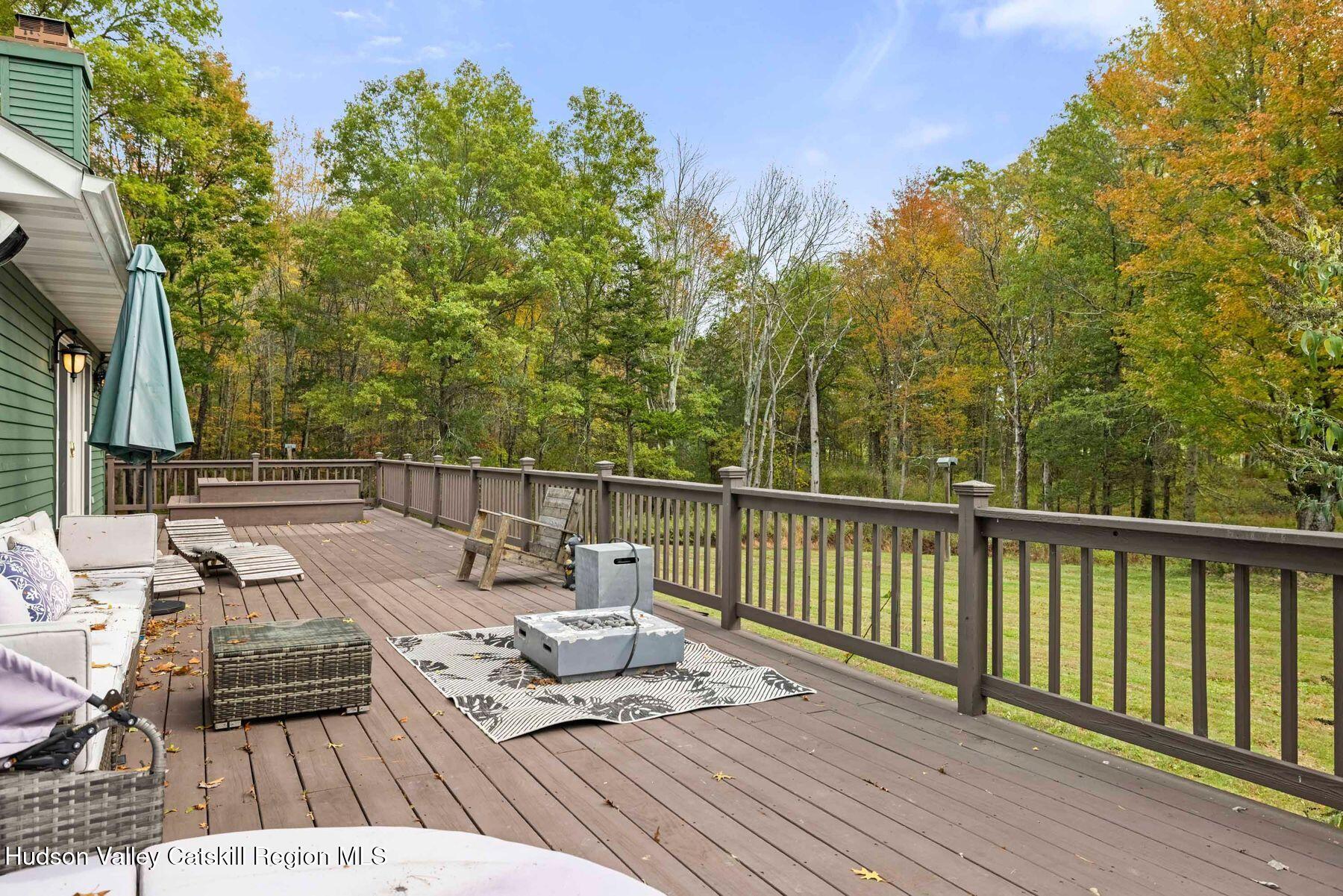 2935 Rte 44 55 Gardiner, NY 12525 - Photo 69 of 87 a view of a deck with couches table and chairs with wooden floor and fence