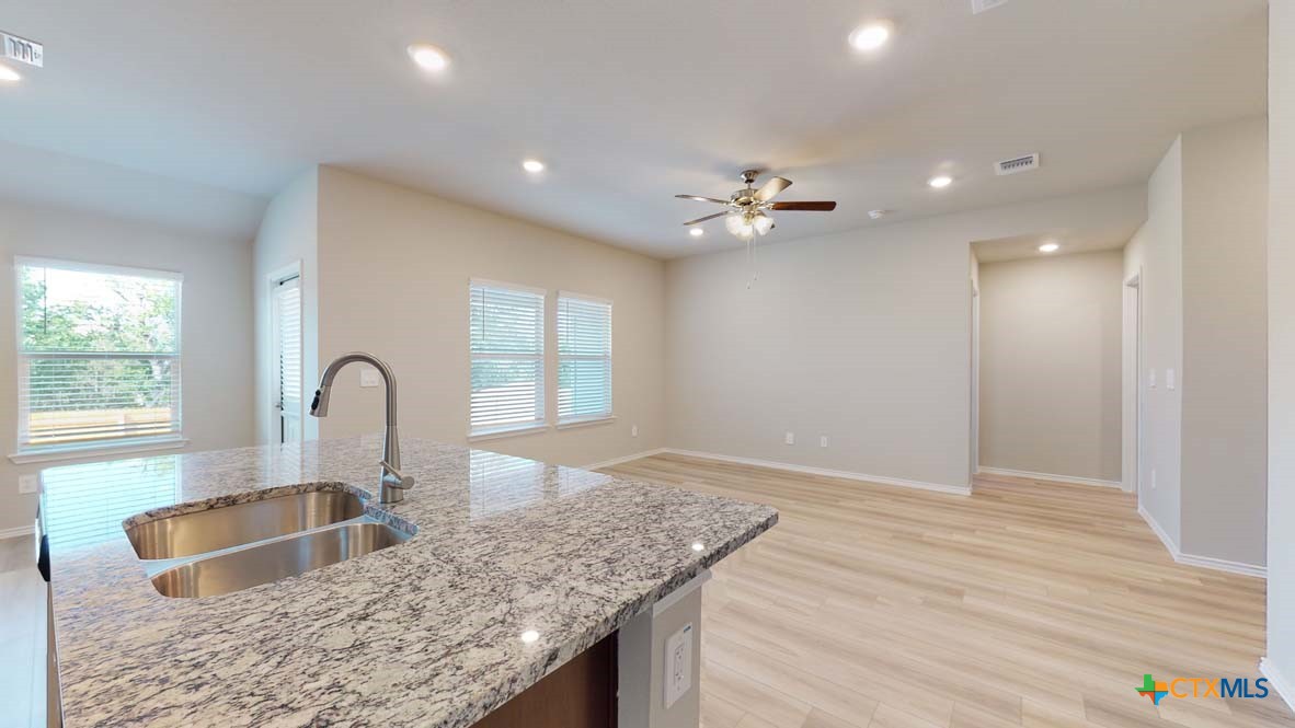 549 Hector Loop Georgetown, TX 78626 - Photo 12 of 22 a kitchen with granite countertop a sink and a large window