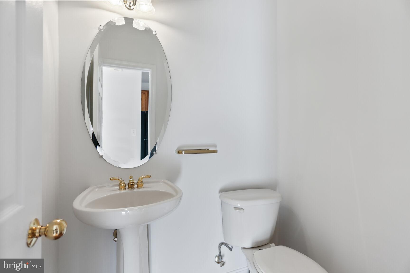 5133 Gardner Drive Alexandria, VA 22304 - Photo 11 of 25 a bathroom with a toilet sink and mirror