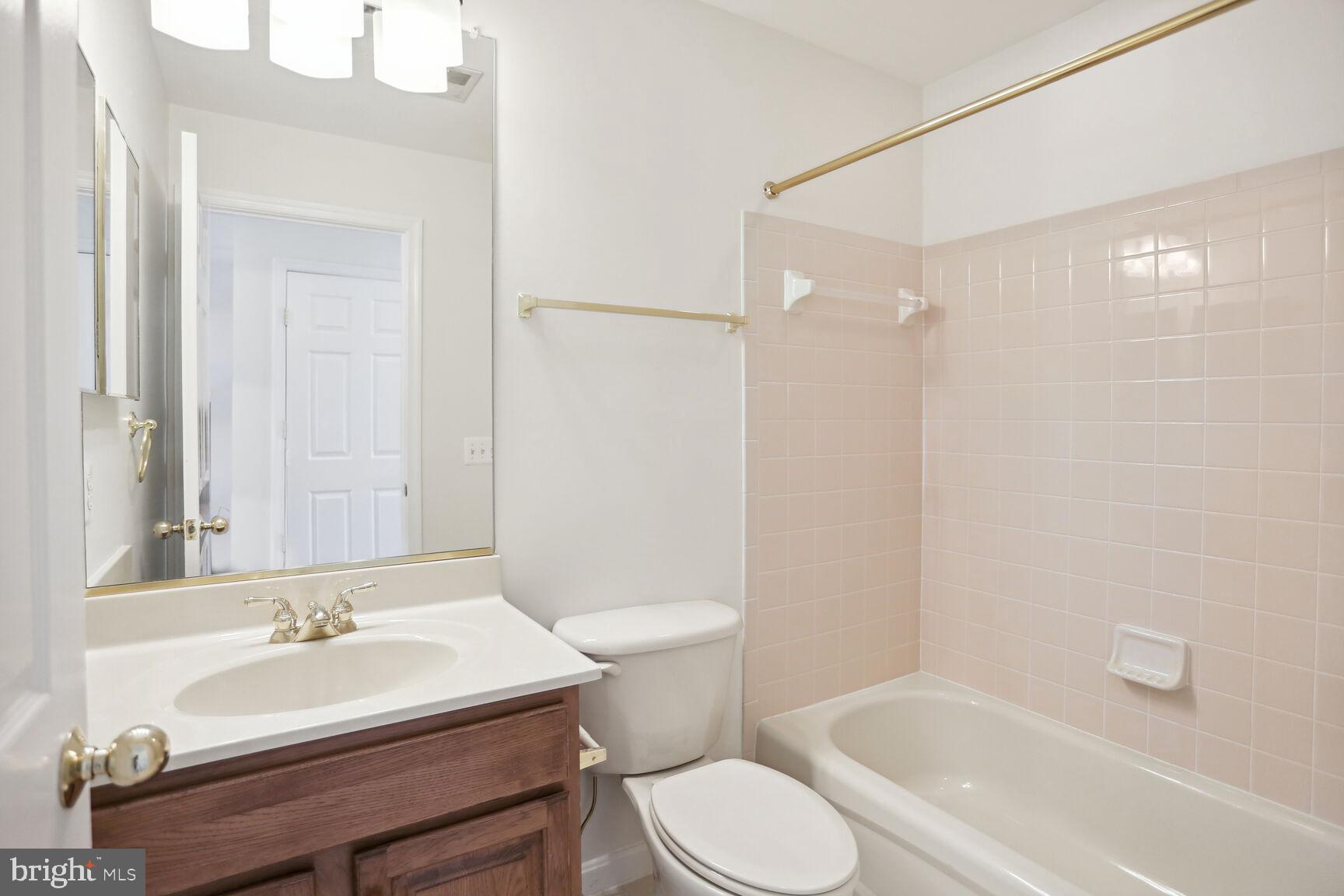 5133 Gardner Drive Alexandria, VA 22304 - Photo 15 of 25 a bathroom with a sink a toilet and a mirror
