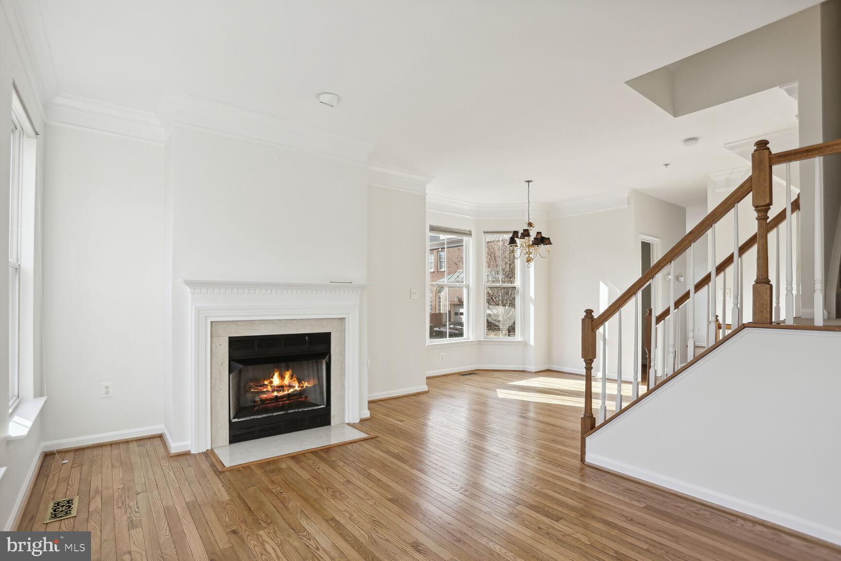 5133 Gardner Drive Alexandria, VA 22304 - Photo 3 of 25 a view of an empty room with wooden floor fireplace and a window