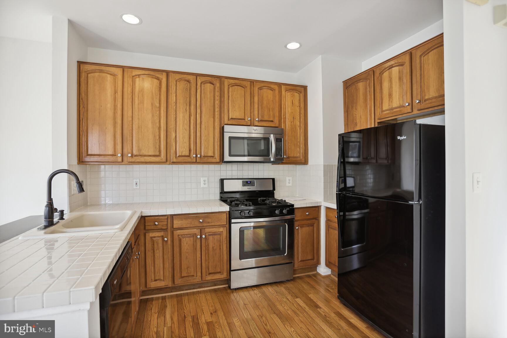 5133 Gardner Drive Alexandria, VA 22304 - Photo 7 of 25 a kitchen with a refrigerator stove and sink