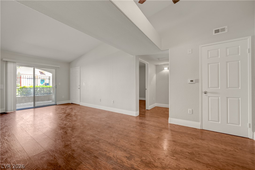 7885 West Flamingo Road, Unit 1050 Las Vegas, NV 89147 - Photo 11 of 62 Hardwood floors and soaring vaulted ceilings define this inviting main living area.