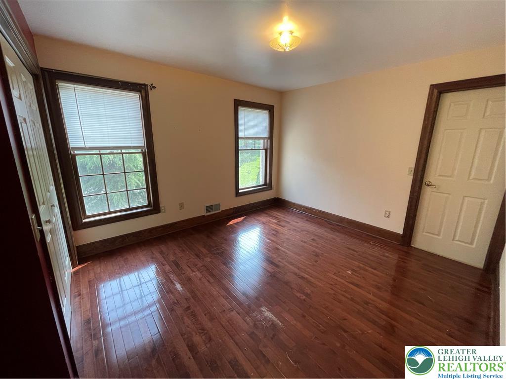 459 Mt Pleasant Road Bangor, PA 18013 - Photo 72 of 86 an empty room with wooden floor and windows
