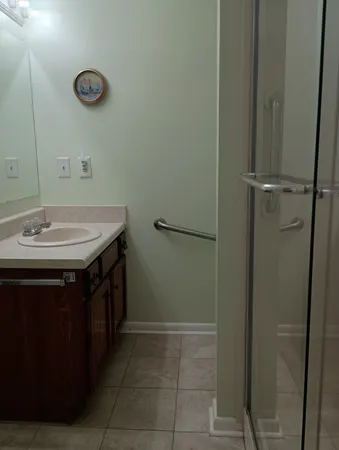 a bathroom with a sink vanity and a mirror
