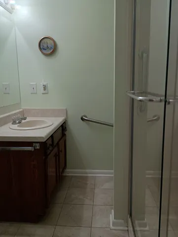a bathroom with a sink vanity and a mirror