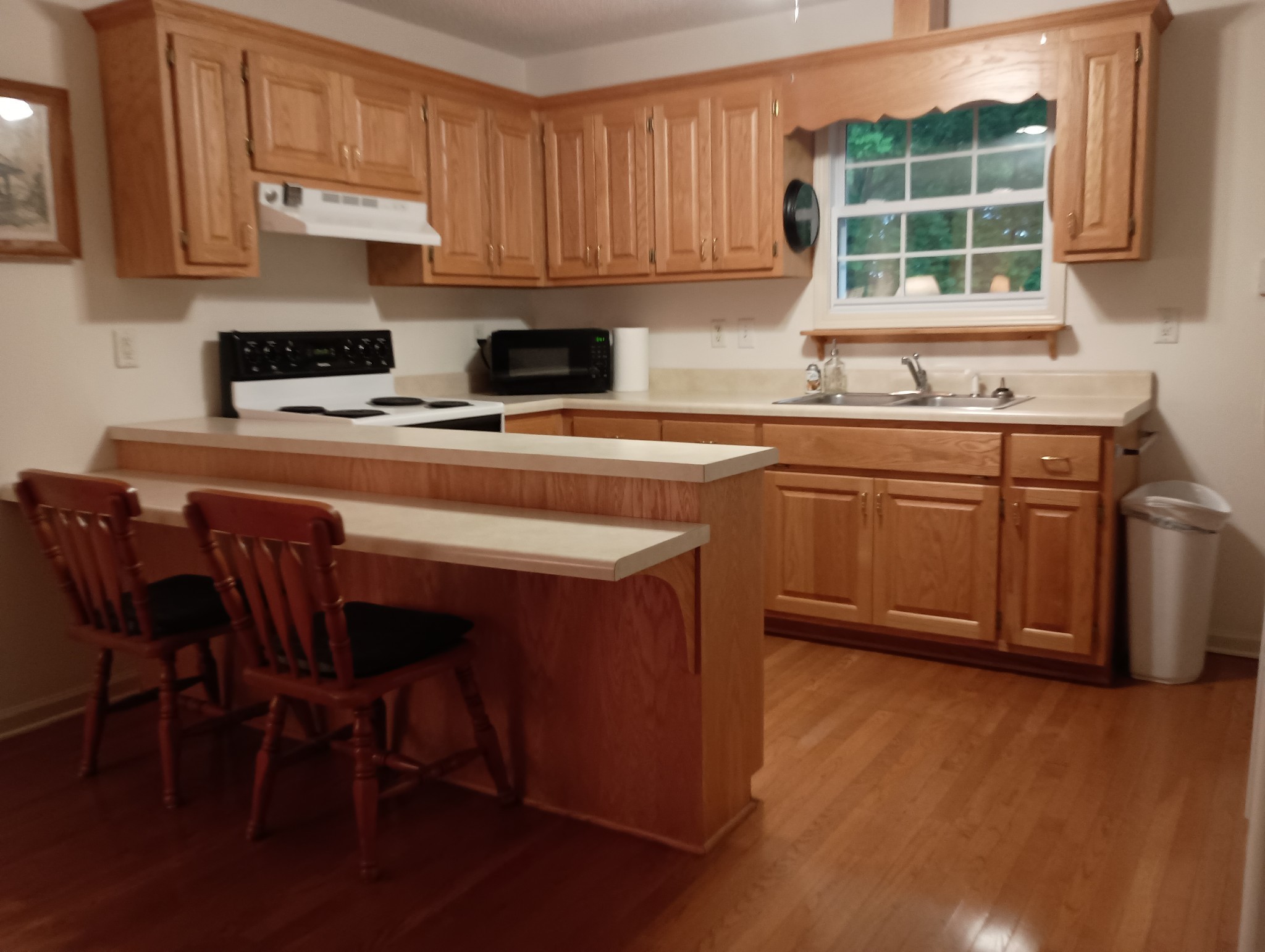 161 Kentucky Avenue Sewanee, TN 37375 - Photo 5 of 12 a kitchen with stainless steel appliances granite countertop a stove a sink a microwave refrigerator and cabinets