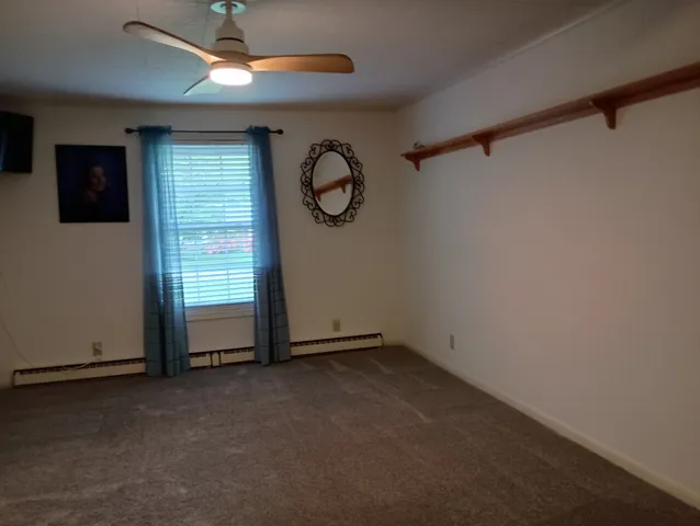 a view of room with window and ceiling fan
