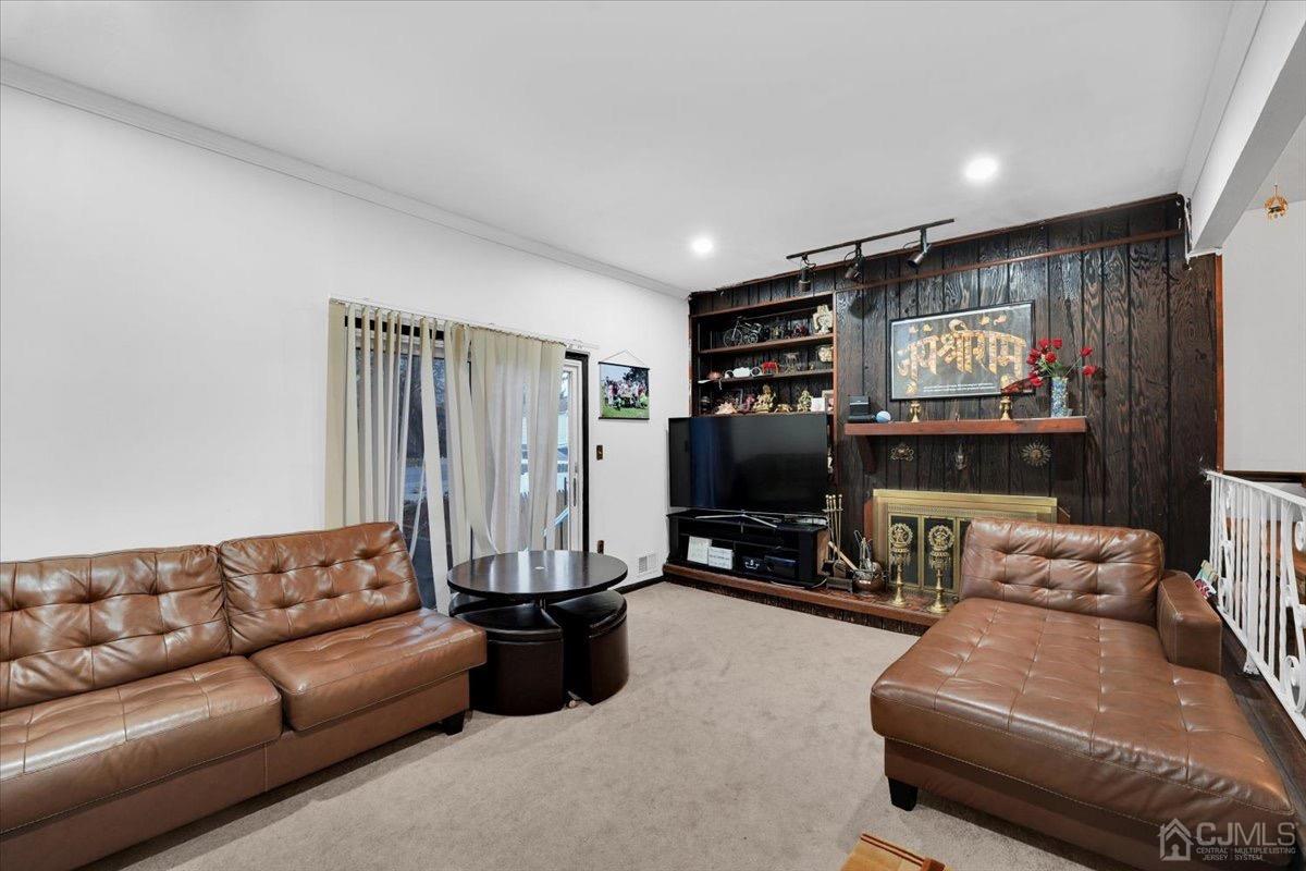 145 Jefferson Boulevard Edison, NJ 08817 - Photo 11 of 35 a living room with furniture a projector and a flat screen tv