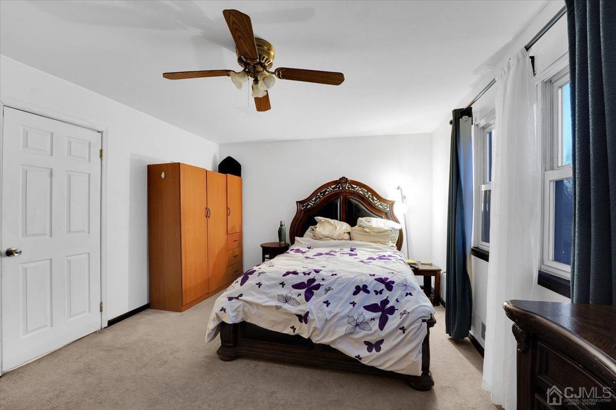 145 Jefferson Boulevard Edison, NJ 08817 - Photo 17 of 35 a bedroom with a bed and a refrigerator