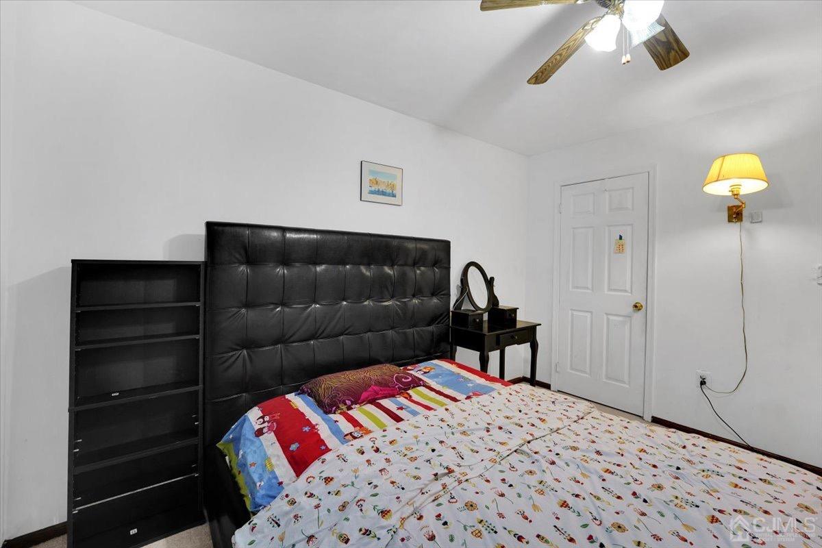 145 Jefferson Boulevard Edison, NJ 08817 - Photo 21 of 35 a bedroom with a bed and a chandelier
