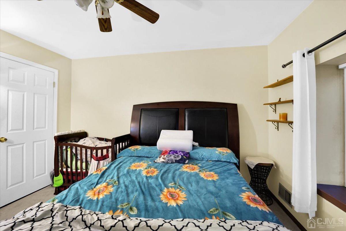 145 Jefferson Boulevard Edison, NJ 08817 - Photo 24 of 35 a bedroom with a bed and wooden floor