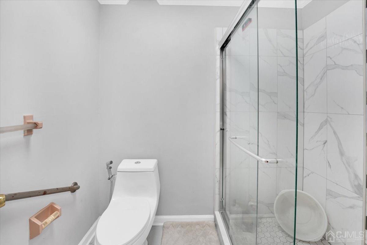 145 Jefferson Boulevard Edison, NJ 08817 - Photo 26 of 35 a white toilet sitting next to a bathroom sink