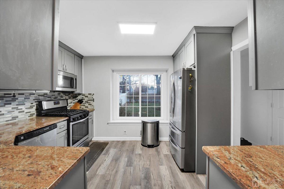 145 Jefferson Boulevard Edison, NJ 08817 - Photo 7 of 35 a kitchen with stainless steel appliances granite countertop a refrigerator stove and sink