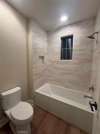 a bathroom with a toilet and a bathtub