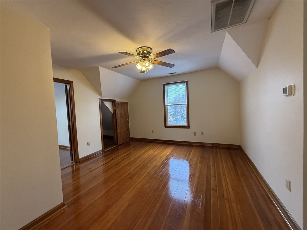 132 Coburn Avenue, Unit 3 Worcester, MA 01604 - Photo 10 of 18 a view of an empty room with window and wooden floor