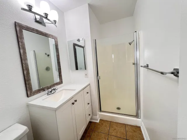 a bathroom with a sink a toilet and mirror