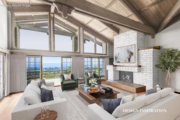 a living room with furniture fireplace and a large window