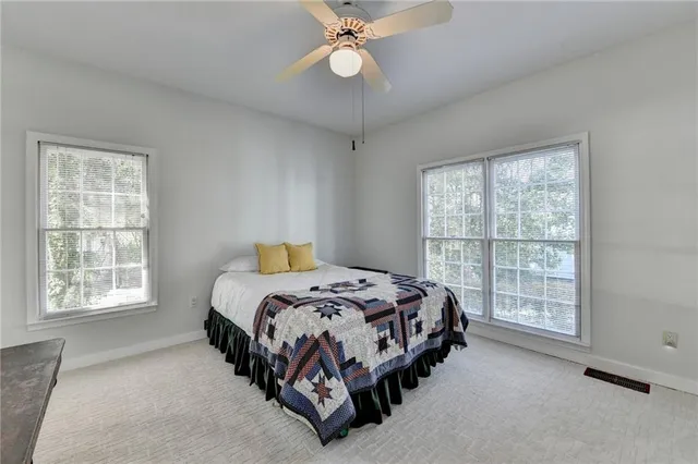 a bed sitting in a bedroom next to a window